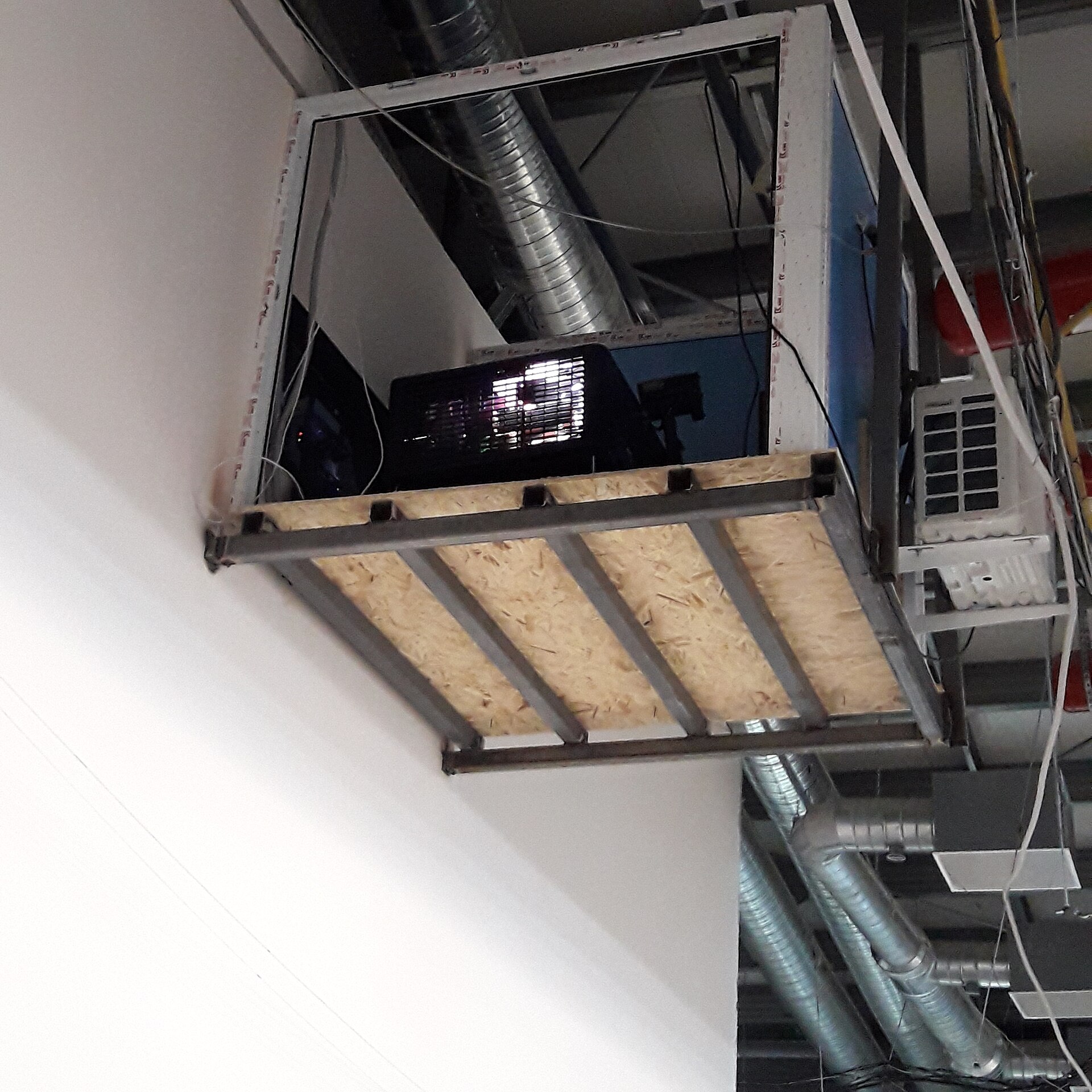 A ceiling void reveals the infrastructure supporting film distribution and projection equipment.