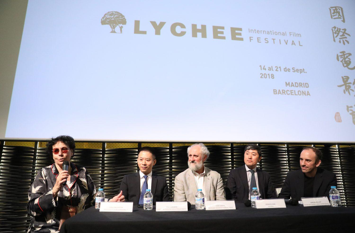 A panel discussion takes place at the Lychee International Film Festival, showcasing vibrant festival culture.