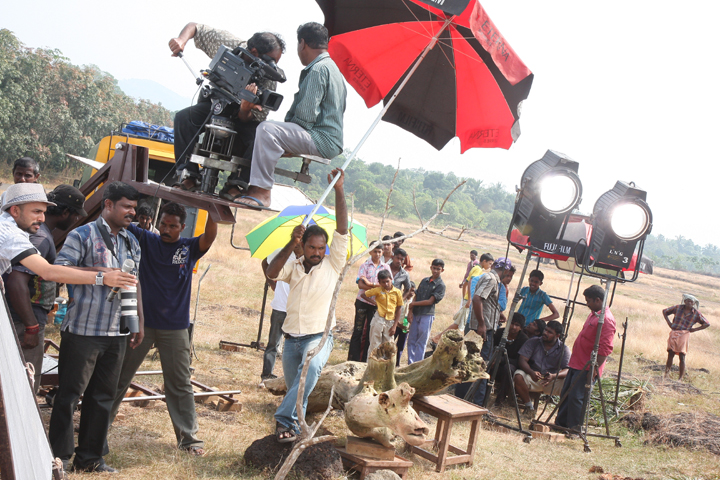 A film crew works on location during a movie shoot, showcasing the vibrant world of indian cinema.
