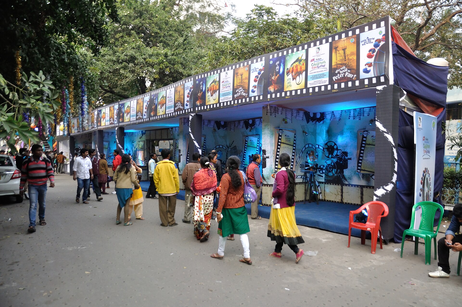 A film festival booth decorated with movie posters shows Indian cinema's presence on the international stage.